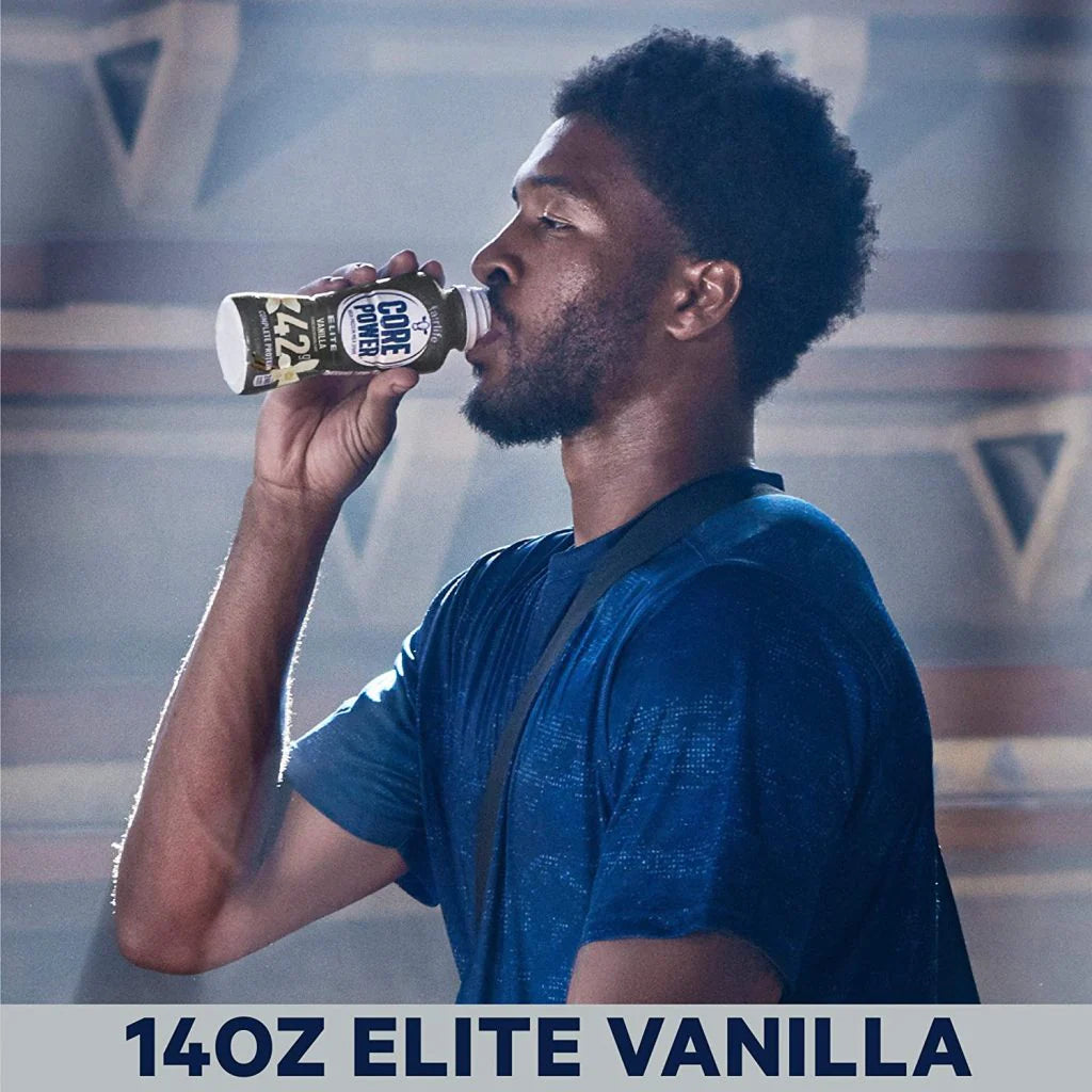 Man in blue shirt drinking a 14oz Fairlife Core Power Elite Vanilla protein shake.